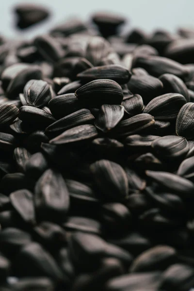 Many black sunflower seeds background close up — Stock Photo, Image