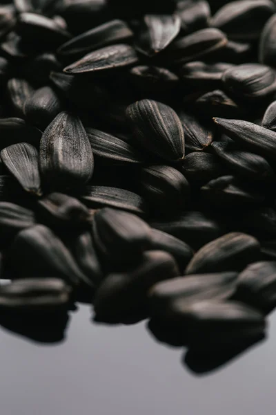 Many black sunflower seeds background close up — Stock Photo, Image