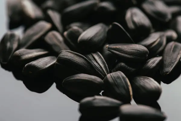 Many black sunflower seeds background close up — Stock Photo, Image