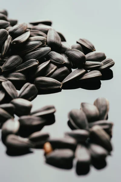 Many black sunflower seeds background close up — Stock Photo, Image