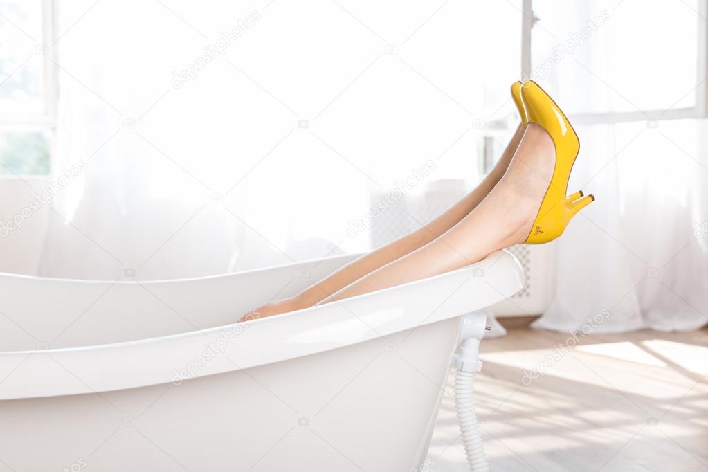 Woman in high heel shoes in bath