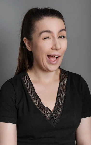 Young Woman Winks Gray Background — Foto Stock