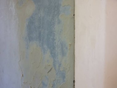 Boya ve alçıdan soyulmuş beyaz bir duvar..