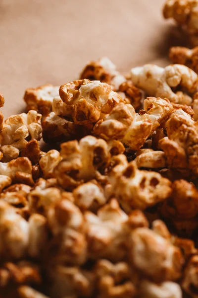 sweet caramel popcorn close-up on light paper