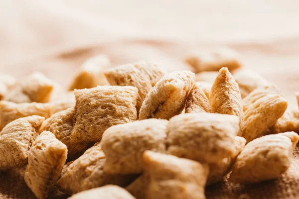 cereal pillows with chocolate filling on sackcloth background