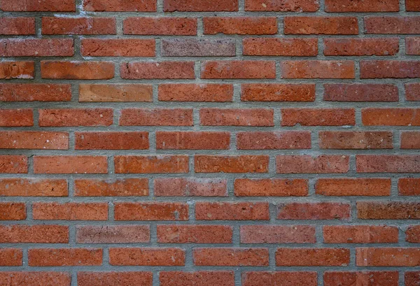 Telaffuz edilmiş dokusu olan kırmızı tuğlalı bir duvar. Fotoğraf, tasarım ve grafik projeleri için arka plan olarak mükemmel.