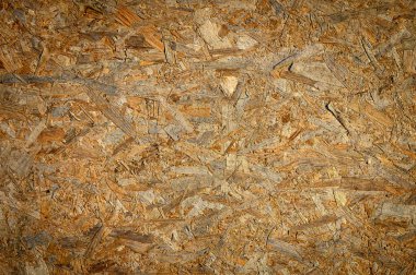 Arka plan için OSB ahşap tahta dokusu yakın plan. OSB 'nin yüksek kalite makro karesi ahşap iplikleri ve dokuları gösteriyor. Arkaplan, inşaat ve tasarım stoku resimleri için mükemmel.