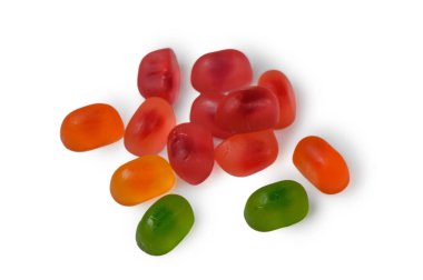 Temiz beyaz arkaplana saçılmış renkli jöle şekerlerinden oluşan canlı bir karışım. Çeşitli şekil ve renklerde parlak, şeffaf tatlılar neşeli ve göz alıcı bir kompozisyon oluşturur..