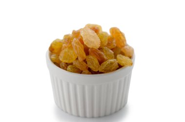 Simple white bowl overflowing with plump golden raisins, professionally photographed on clean white background. Perfect for food and ingredient photography.