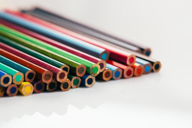 bir kapta beyaz arka plan üzerinde renkli kalemler