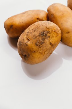Beyaz arka planda taze çiğ patates.