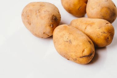 Beyaz arka planda taze çiğ patates.