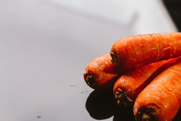 Fresh raw carrots on a black background — Stock Photo, Image