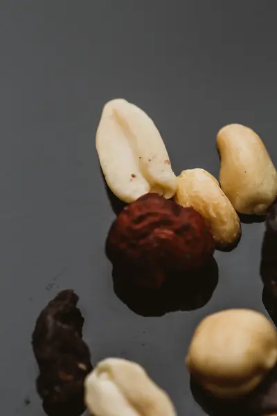 Mixture of nuts and dried fruits on a dark background — Stock Photo, Image