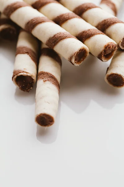 wafer rolls with nut filling on a light mirror background