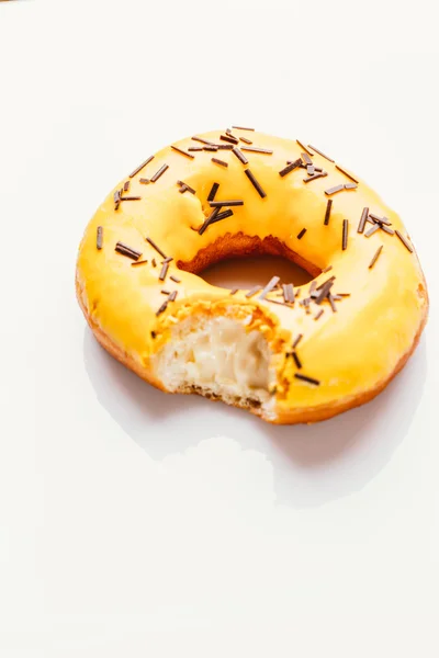 Bitten donut with banana cream on a white background — Stock Photo, Image