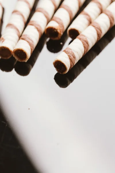 Wafer rolls with nut filling on a mirrored background — Stock Photo, Image