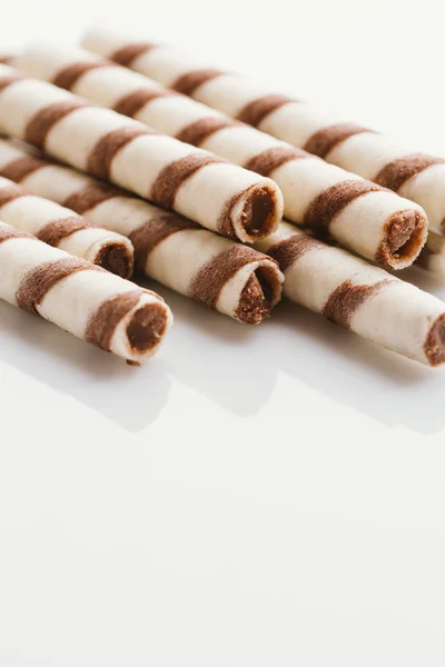 wafer rolls with nut filling on a light mirror background