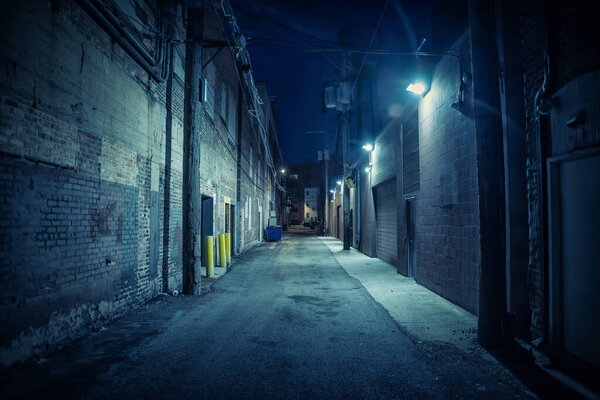 Dark and eerie urban city alley at night