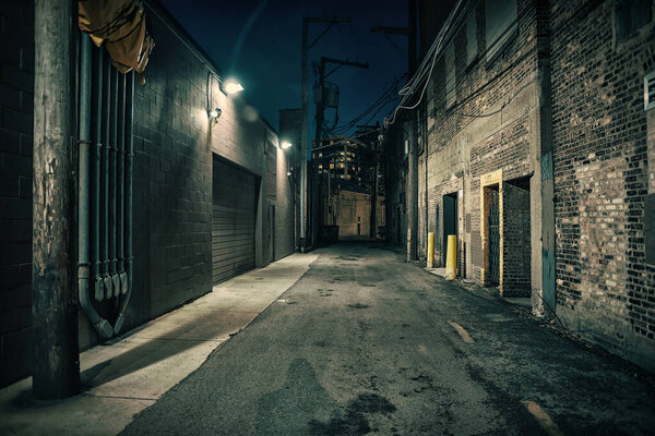 Dark and eerie urban city alley at night