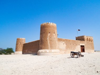 Katar 'daki tarihi El Zubarah kalesi. Önünde bir top var.