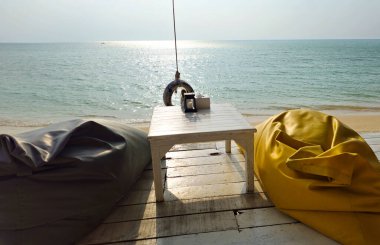 Rahatlatıcı puf minderler ve sahil güvertesinde küçük bir masa, Ko Samui Adası, Surat Thani, Tayland, Güneydoğu Asya.