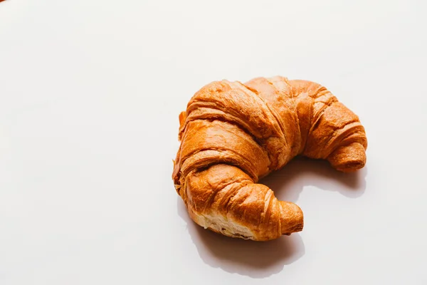 Frisches Croissant aus dem Blätterteig auf weißem Hintergrund — Stockfoto