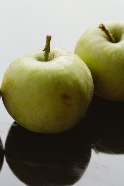 karanlık bir arka plan üzerinde birkaç taze olgun elma