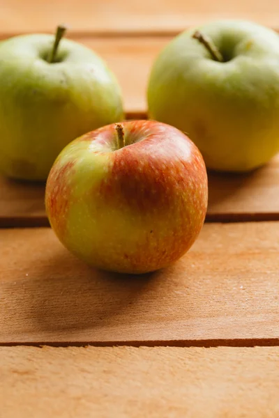 Несколько свежих спелых яблок на деревянном фоне — стоковое фото