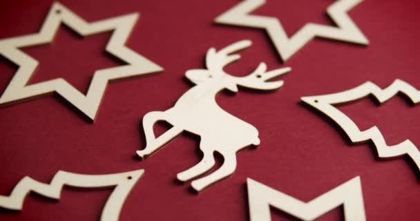 Beautiful wooden Christmas decorations on a burgundy background — Stock Video