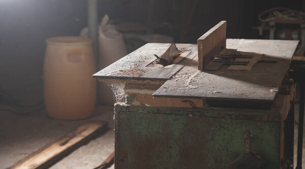 Carpentry machine with a piece of wood.