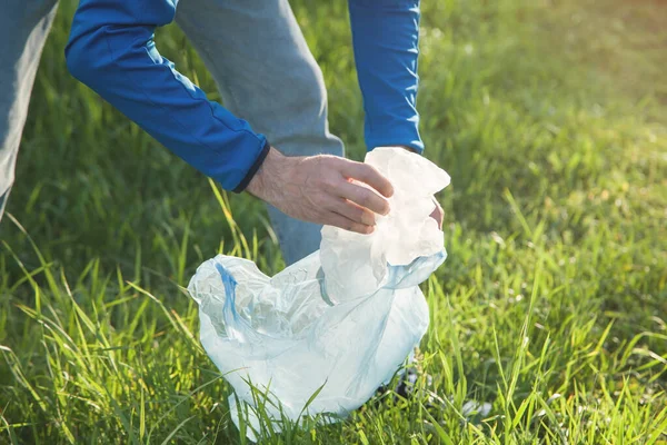 Man Picks Plastic Bag Grass Park — Stock Photo, Image