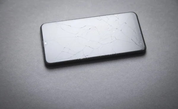Black broken smartphone. Broken screen