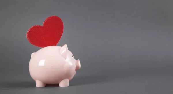 Piggy bank with red heart.