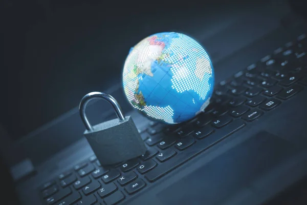 Padlock and globe on laptop keyboard. Global network security