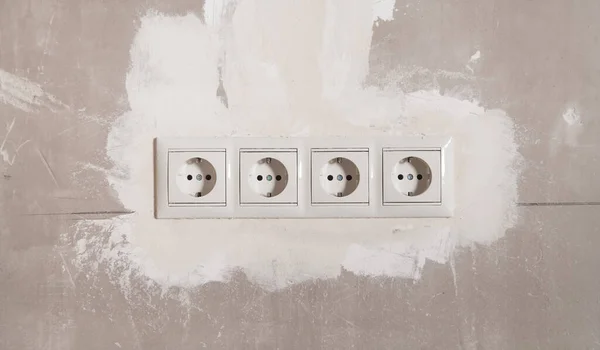 Power sockets on a wall. Before renovation