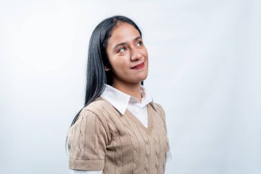 Endonezyalı genç bir kadının düşünceli bakışlı portresi. Görüş, hayal ve temiz beyaz bir arka planda gelecek planı kavramı.