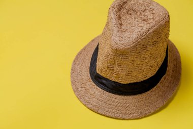 Sarı arka planda hasır şapka ve yaz teması. Mesaj için yer var. Şapka konsepti. Sombrero kavramı.