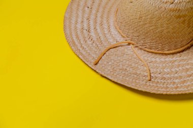 Sarı arka planda hasır şapka ve yaz teması. Mesaj için yer var. Şapka konsepti. Sombrero kavramı.