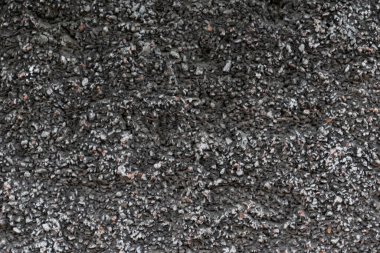 Unique textured surface with small rock fragments. Perfect for backgrounds, overlays, or adding a natural, rough feel to designs needing an urban touch.