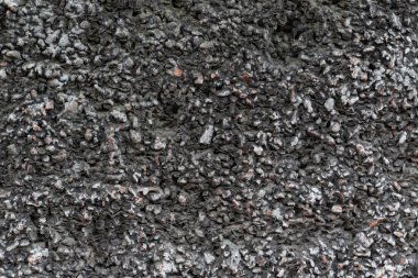 Gritty stucco wall texture provides a rough, urban backdrop. Its textured aggregate finish adds depth and visual interest for unique designs and overlays.