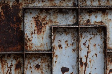 Distressed metal with peeling paint and rust provides a compelling industrial texture. Ideal for backgrounds, design overlays, or adding a weathered grunge aesthetic.
