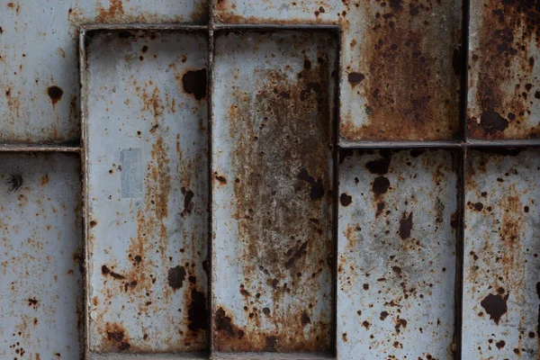 Authentic rusted metal grid with a gritty, weathered texture. Perfect for adding an industrial grunge effect to designs and creative projects. Use for backgrounds or overlays.