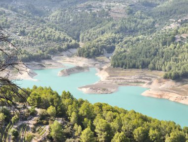 An absolutely stunning and breathtaking aerial view of a serene and calm lake embraced by lush, vibrant greenery