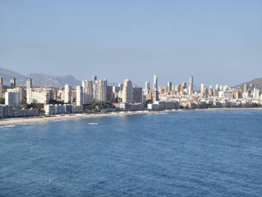 Stunning coastal skyline with modern architecture and clear blue waters, ideal for travel and leisure themes.