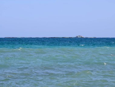 blue sea with white waves, blue sky
