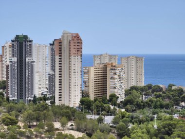 Canlı yeşilliklerle çevrili pitoresk bir sahil şeridi boyunca çağdaş yükselişlerin nefes kesici manzarasının tadını çıkarın.