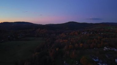 serene rural panorama, scenic twilight scenes over rolling farmland and remote village lights