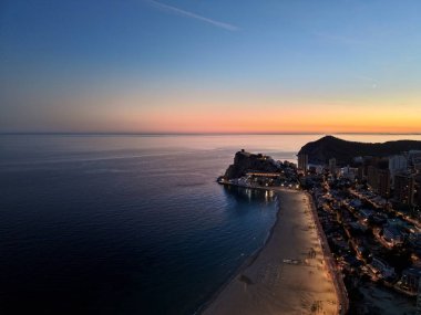 Gün batımı sahil manzarası sahile bakan, insansız hava aracı iskelesi limanı ve aydınlık gezinti güvertesi olan uçurumlar.