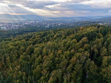 Güneş ışınları Ormanın Altın Kuyularını delip geçen Bulut Uzak Şehir ve Vadiyi aydınlatıyor